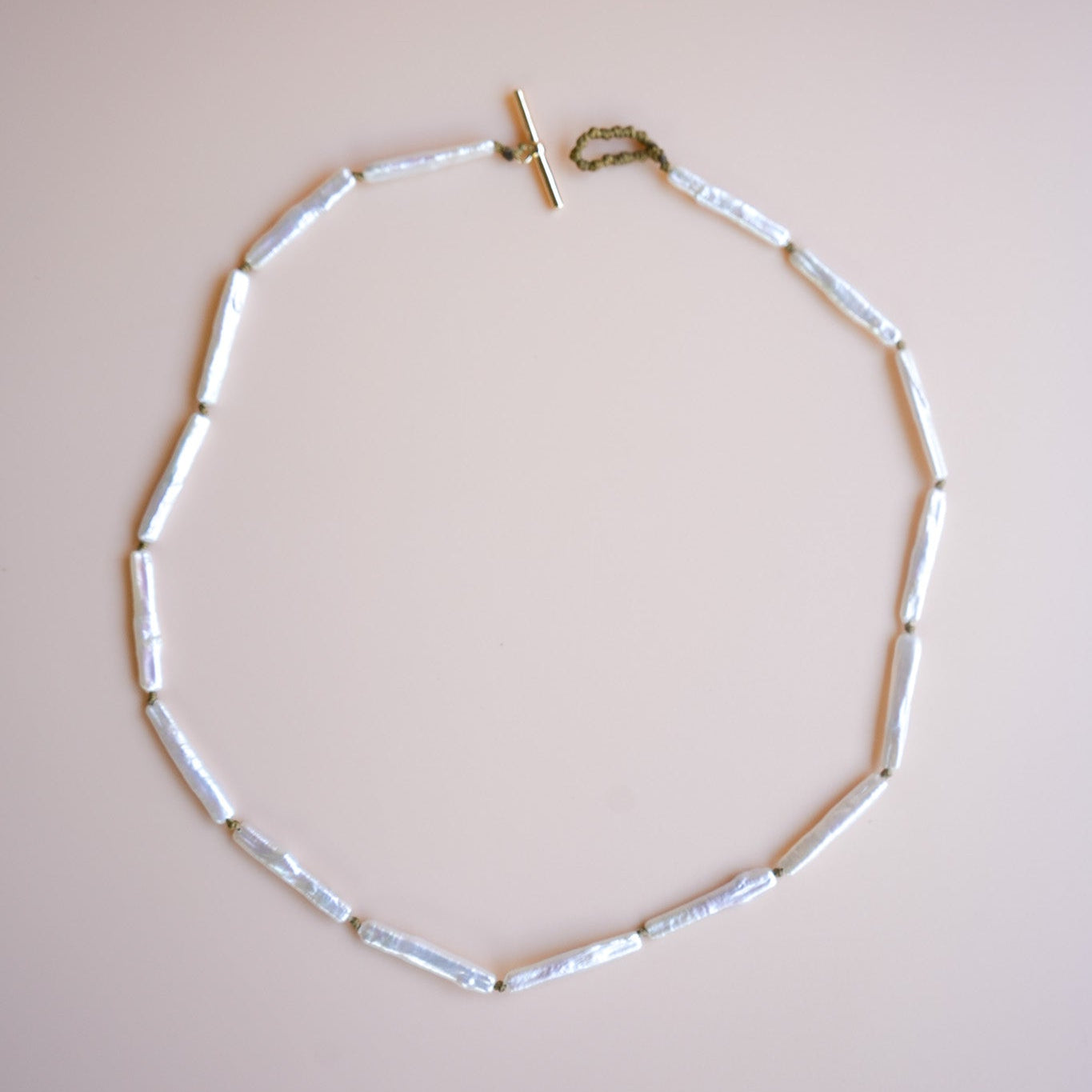 Necklace with biwa pearls on a beige background